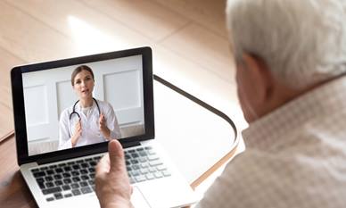 Elderly man on video call with doctor