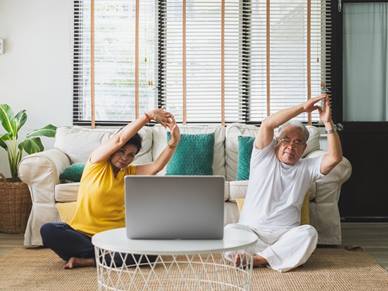 Elderly couple doing online exercise class