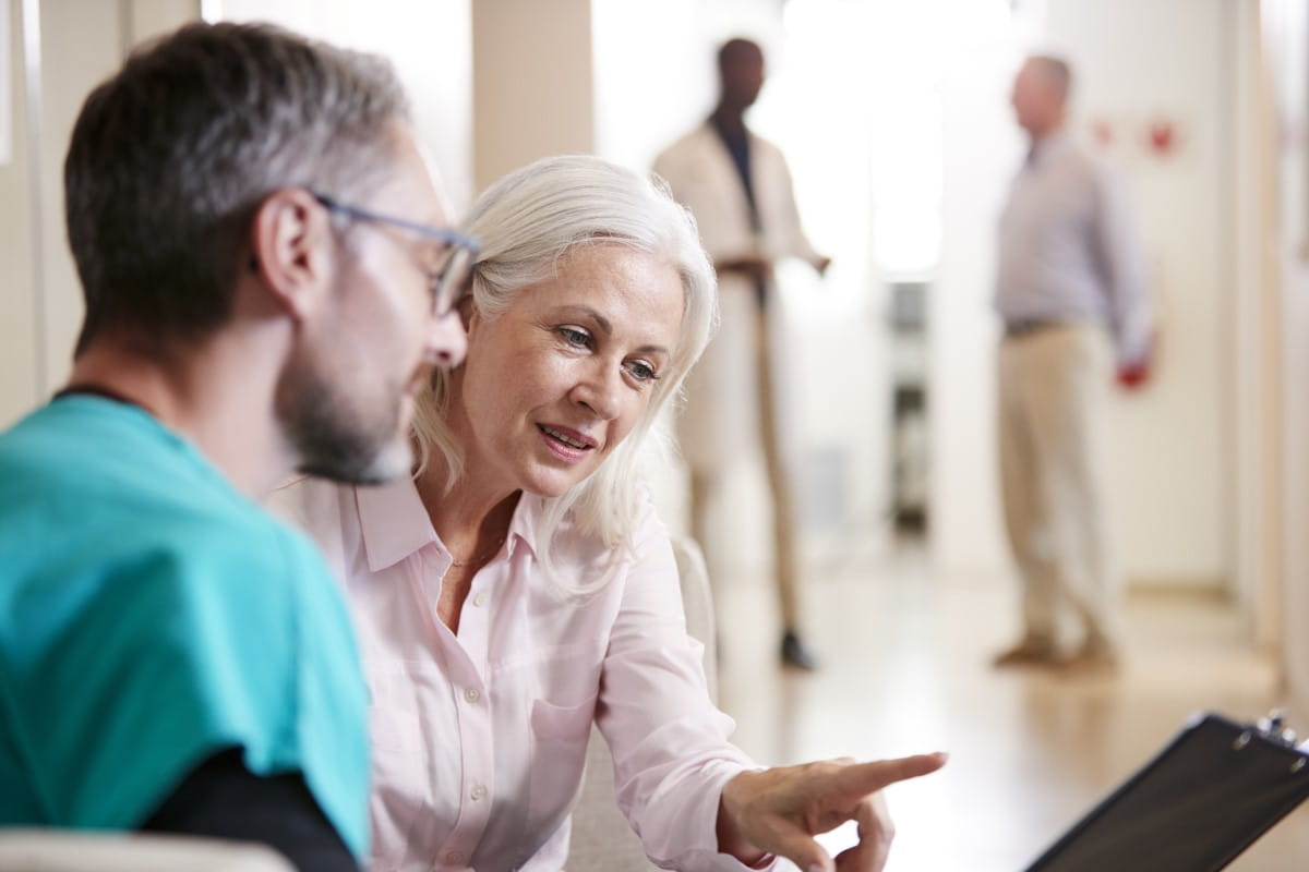 Elderly woman discussing with a doctor