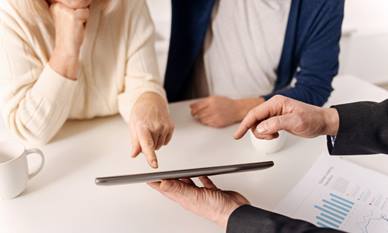 Elderly couple making a selection on a tablet device
