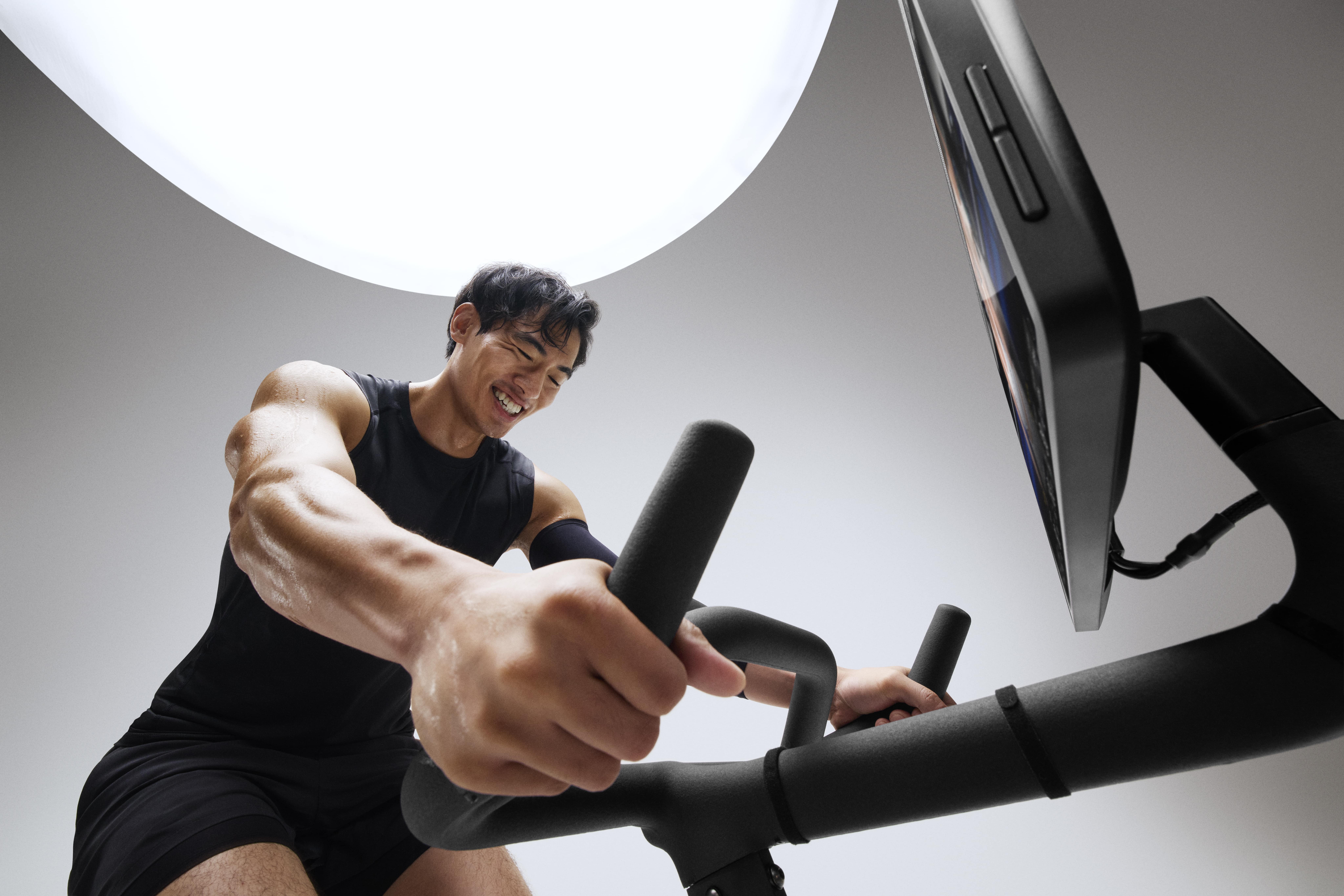 Man exercising on Peloton Cross Training Bike