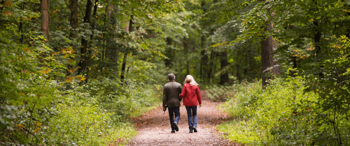 couple-walking-in-wooded-area