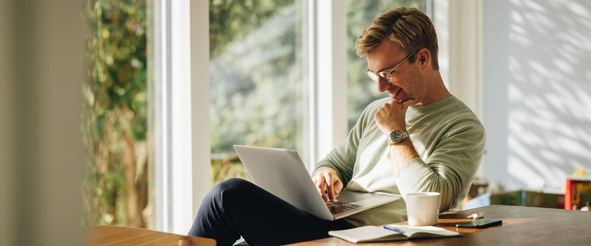 man-looking-at-laptop-at-home
