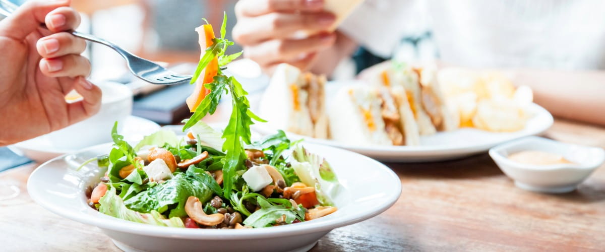 person-eating-salad-with-a-fork