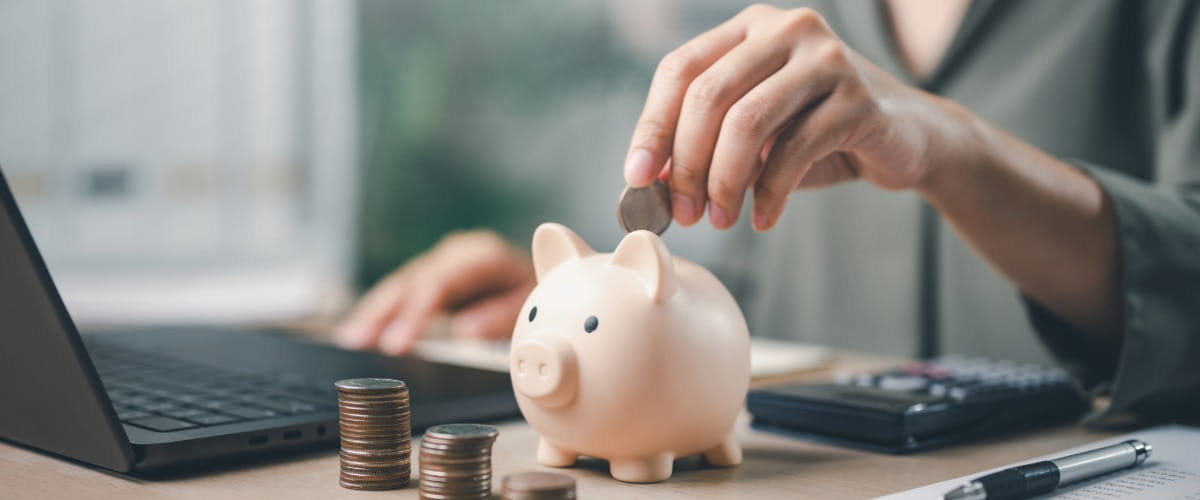 person-putting-money-in-a-piggybank