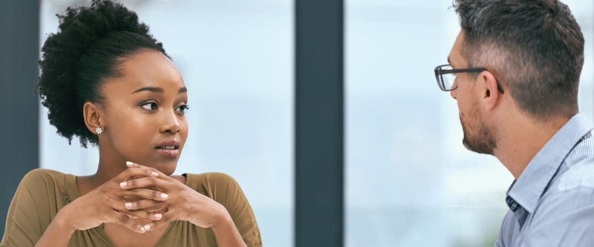 two-colleagues-talking-in-an-office