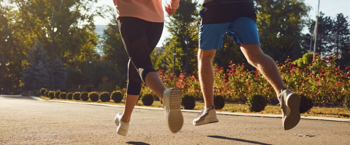 two-people-running-on-a-path