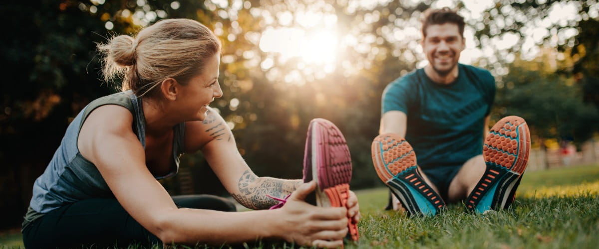 couple-stretching-in-the-park
