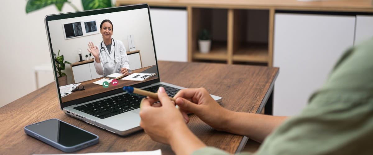 doctor-waving-in-virtual-GP-appointment