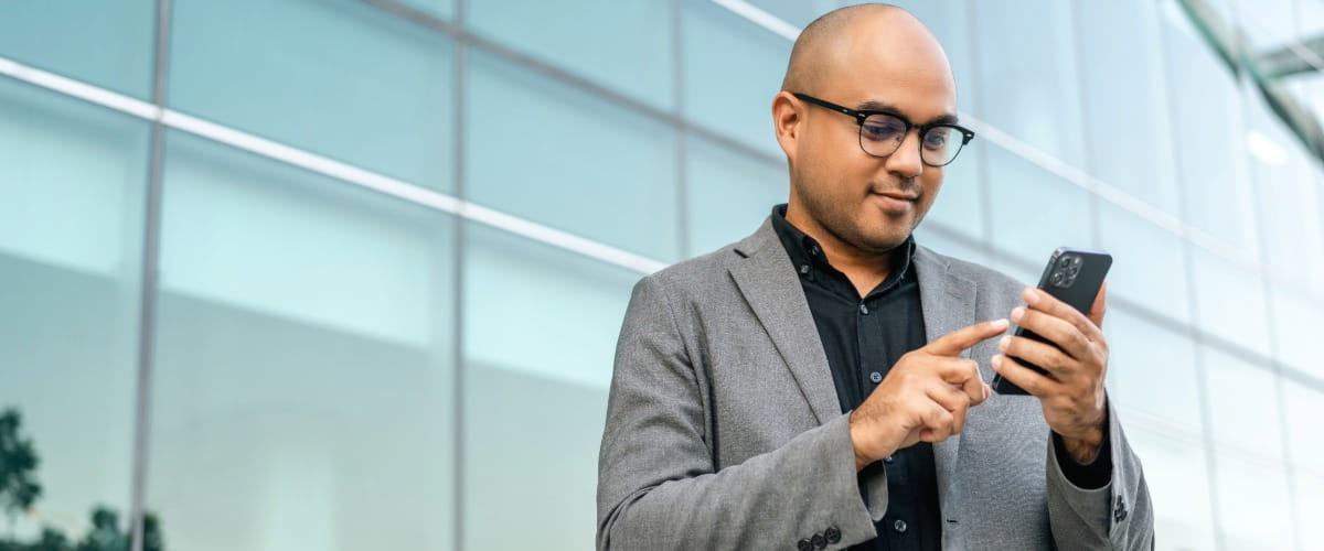 man-looking-at-his-phone